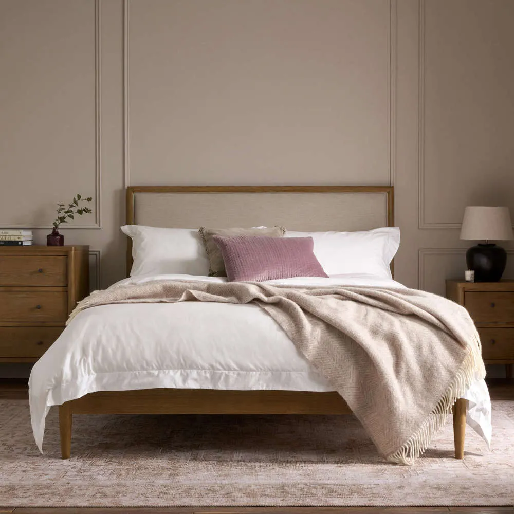 Weathered oak frame bed with upholstered headboard