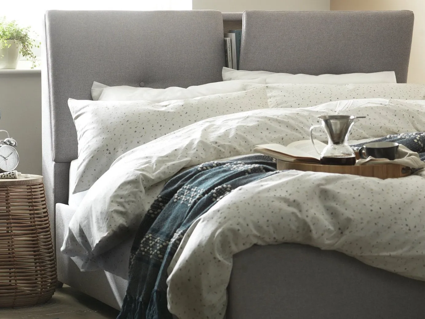 Grey fabric ottoman bed with large split headboard