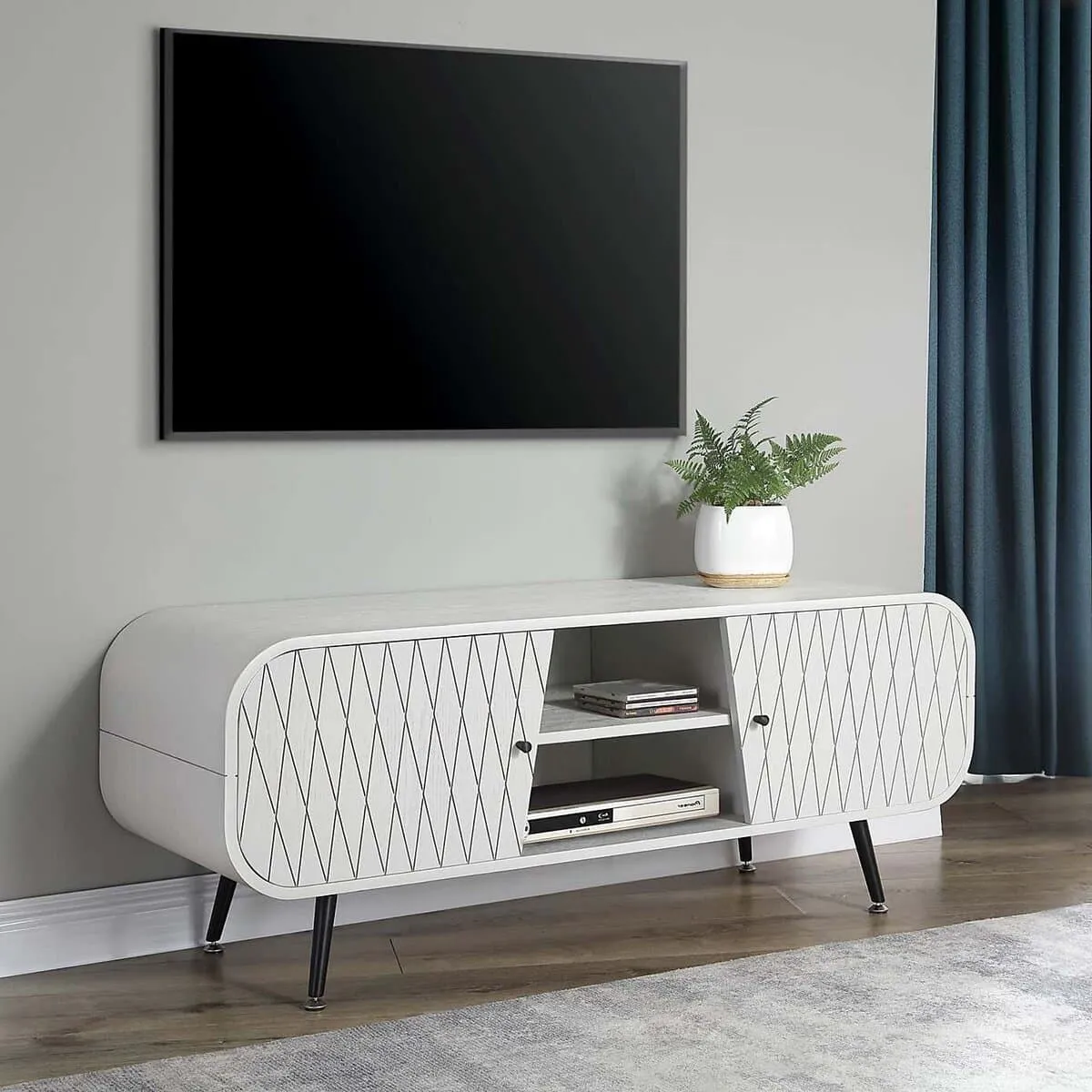 White capsule-shaped tv unit with two lattice pattern doors and a pair of open shelves