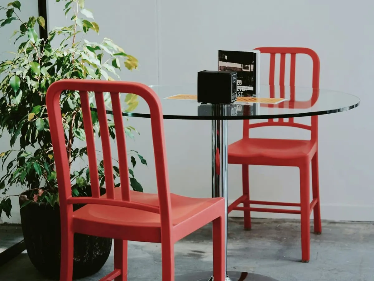 Bold red dining chairs and a glass topped-dining table