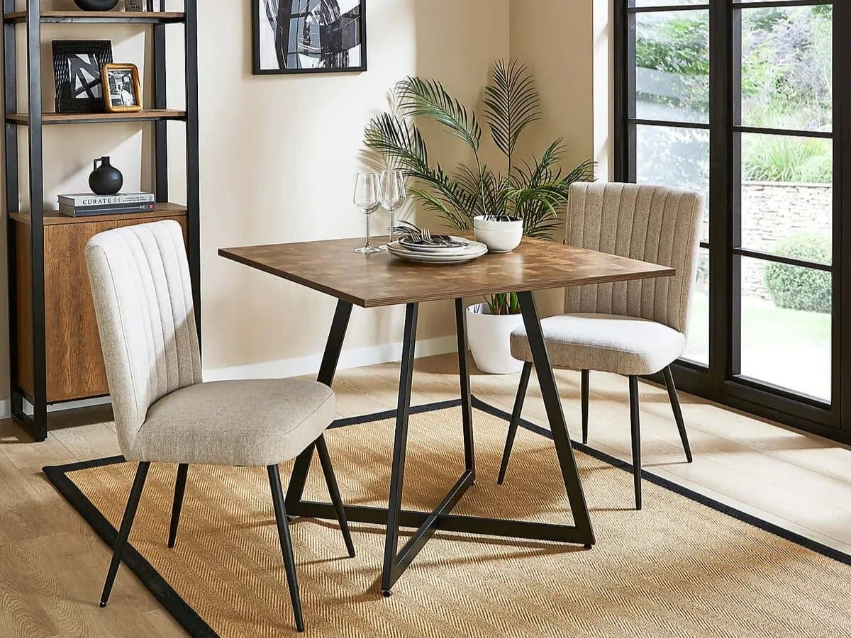 Square dining table with black legs and parquet-style top