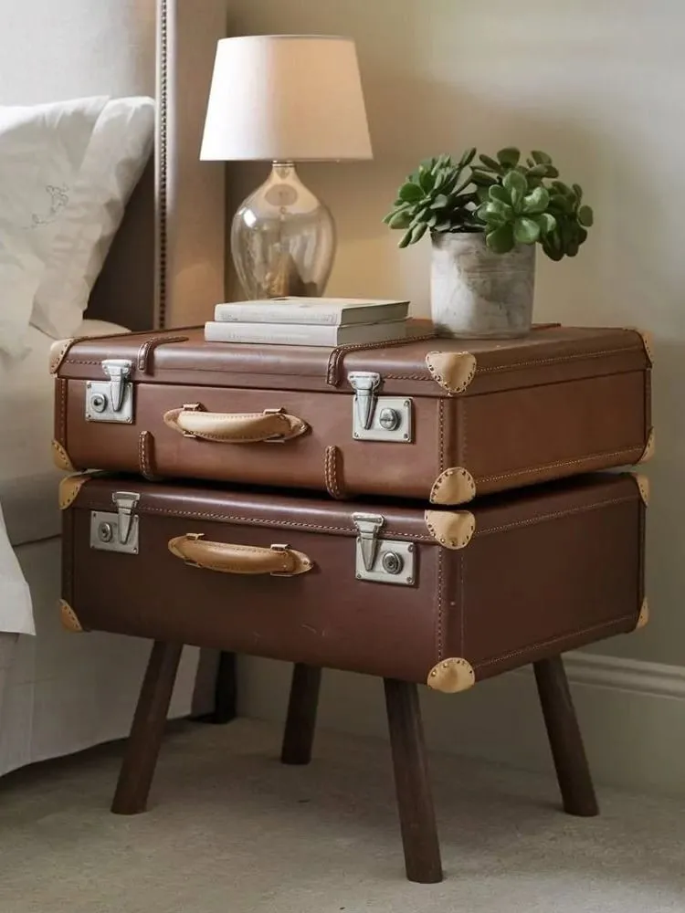 Pair of brown suitcases re-purposed as a bedside table