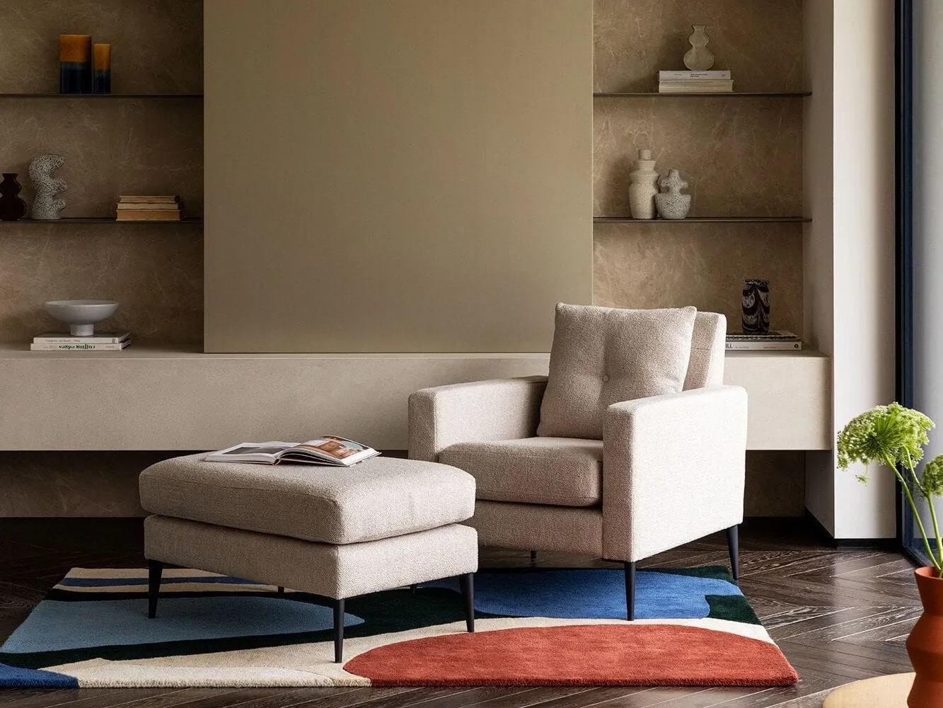 Oatmeal fabric upholstered armchair and matching footstool