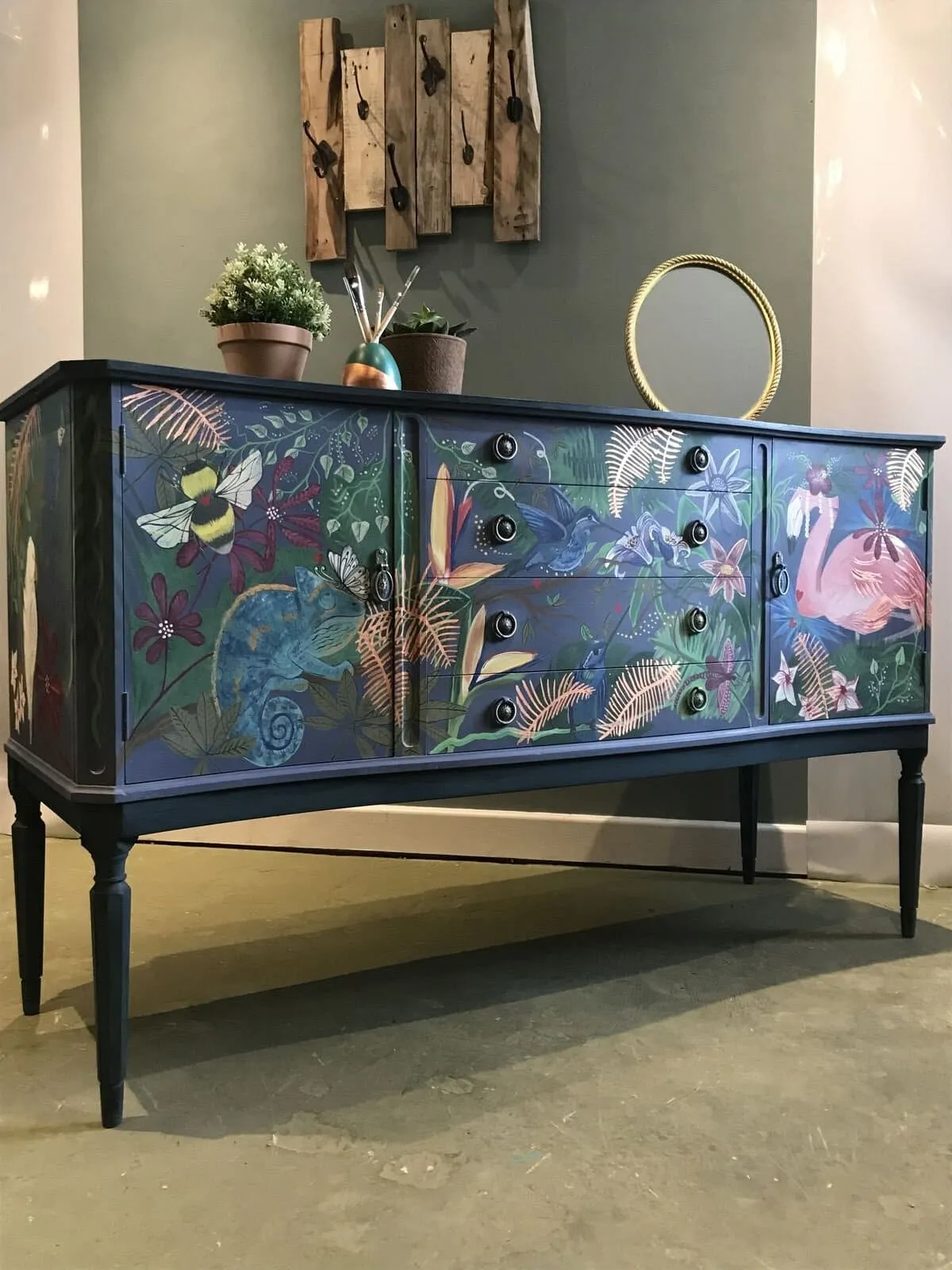 Deep blue sideboard with bold decoupage finish