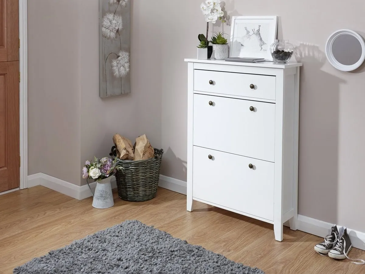 White-painted shoe cabinet with two daoors and a single drawer