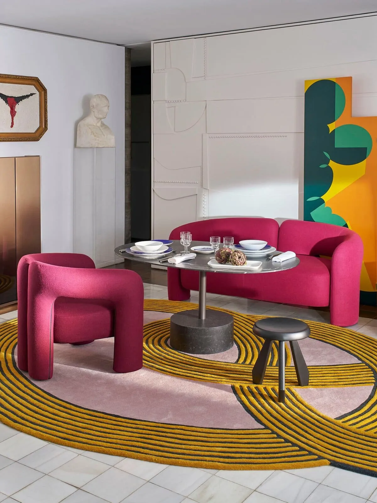 Pink fabric upholstered sofa and armchair with a chunky tubular form