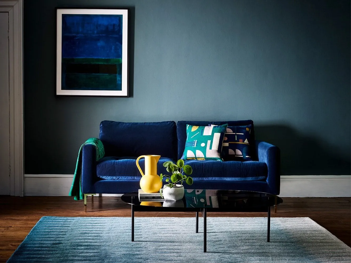 Navy velvet upholstered sofa