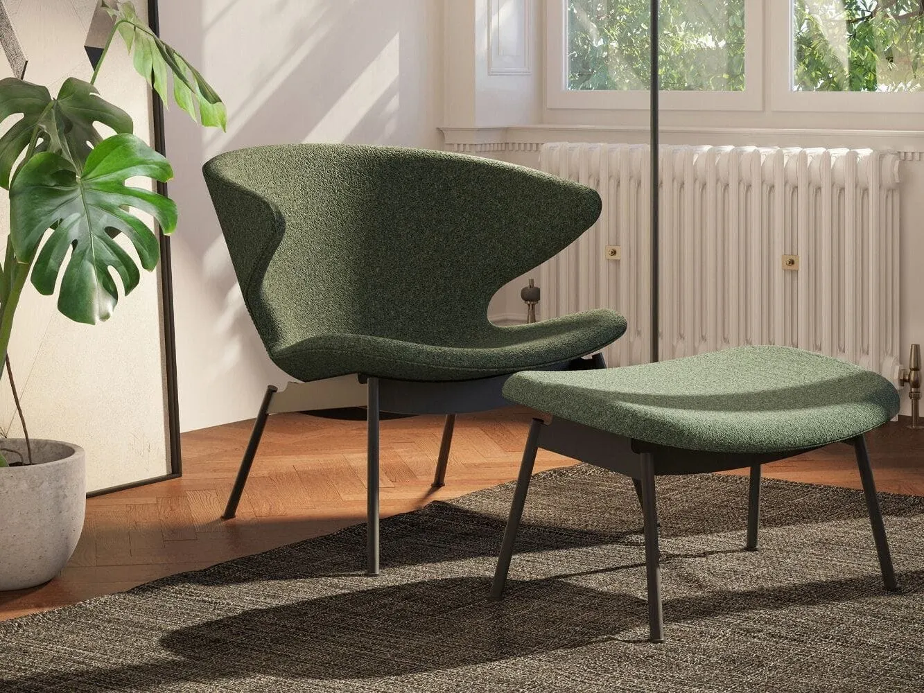 Curved back chair and fott rest upholstered in dark green fabric