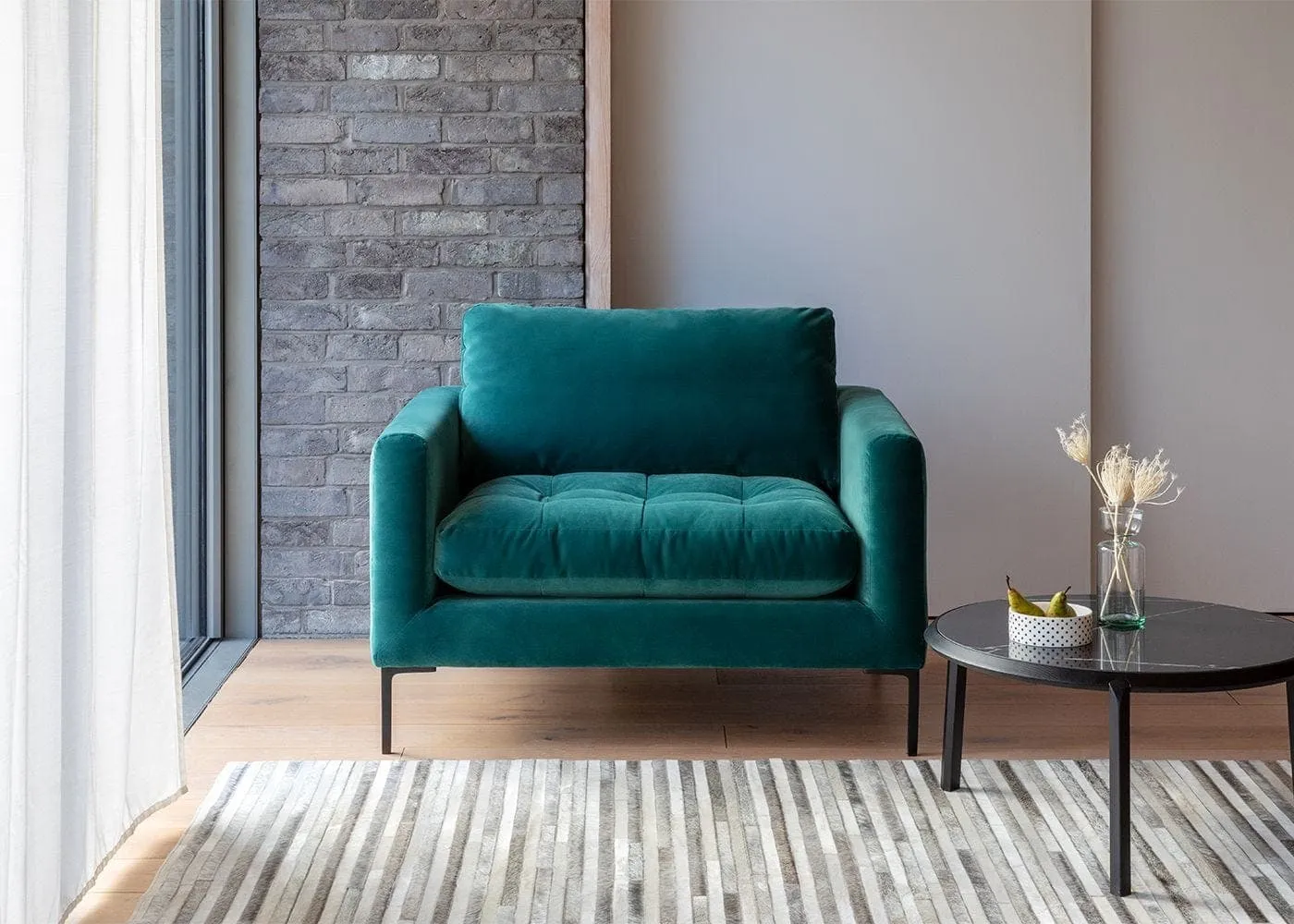 Green velvet upholstered love seat armchair