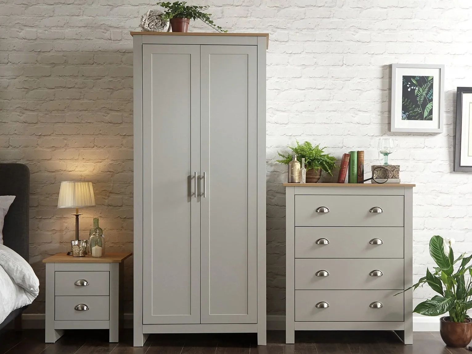 Grey-painted bedroom furniture with metal cup handles and oak trim