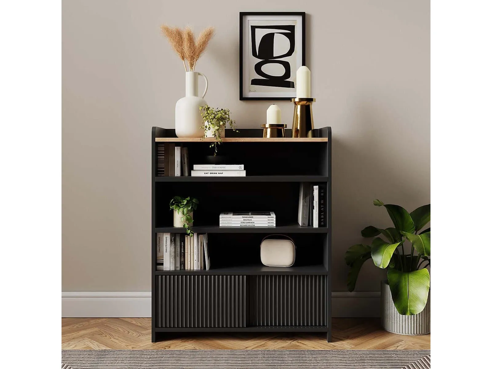 Compact black bookcase with a pair of sliding doors in the base