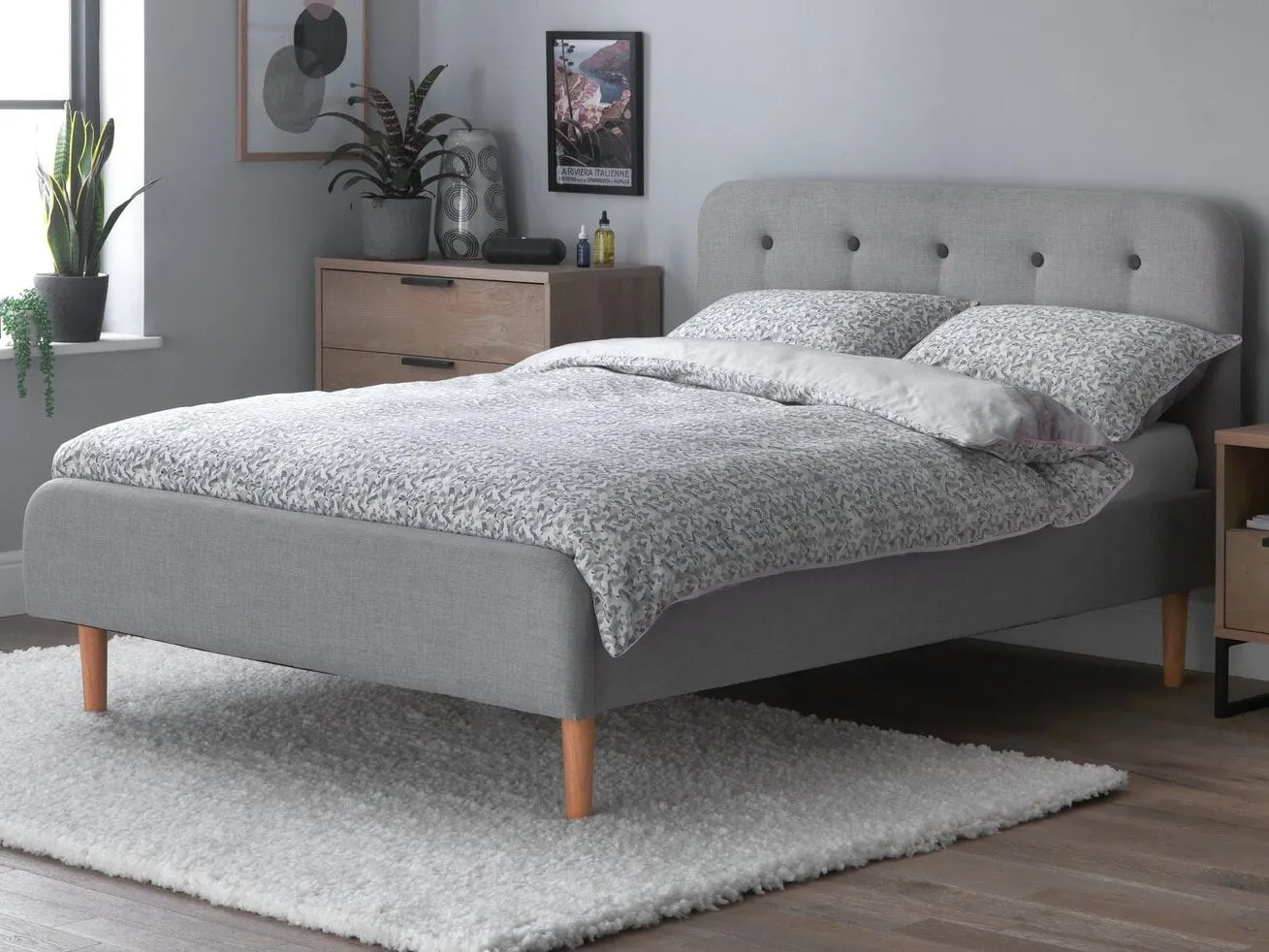 Grey fabric upholstered double bed 