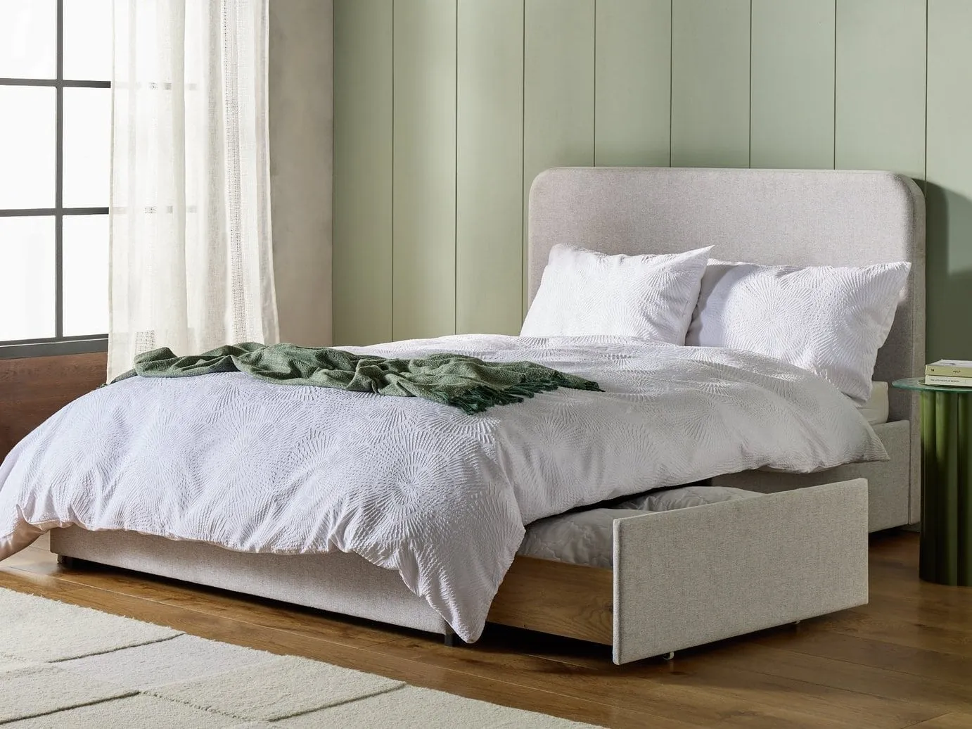 Grey fabric upholstered bed frame with storage drawers