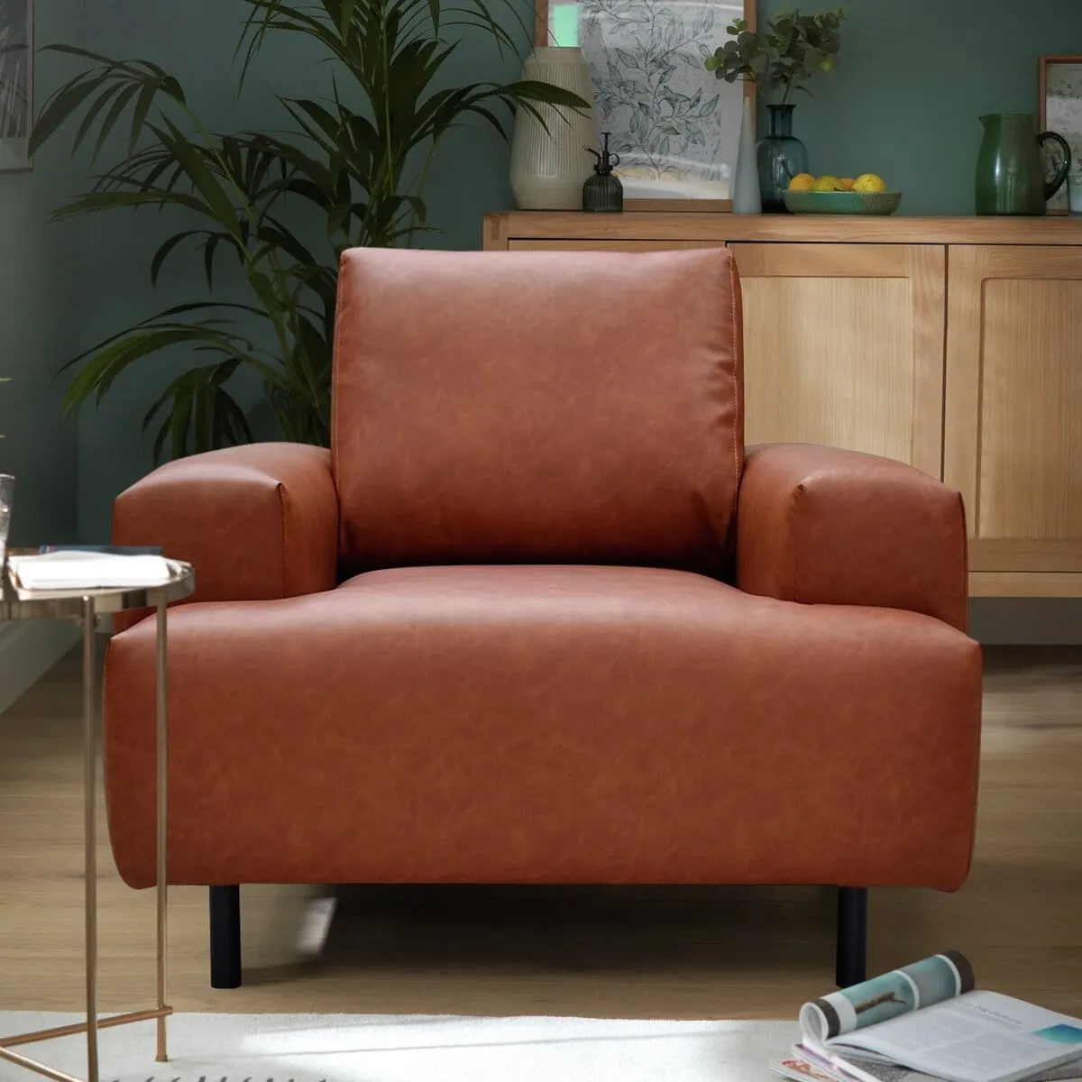 Blocky armchair with tan faux leather upholstery
