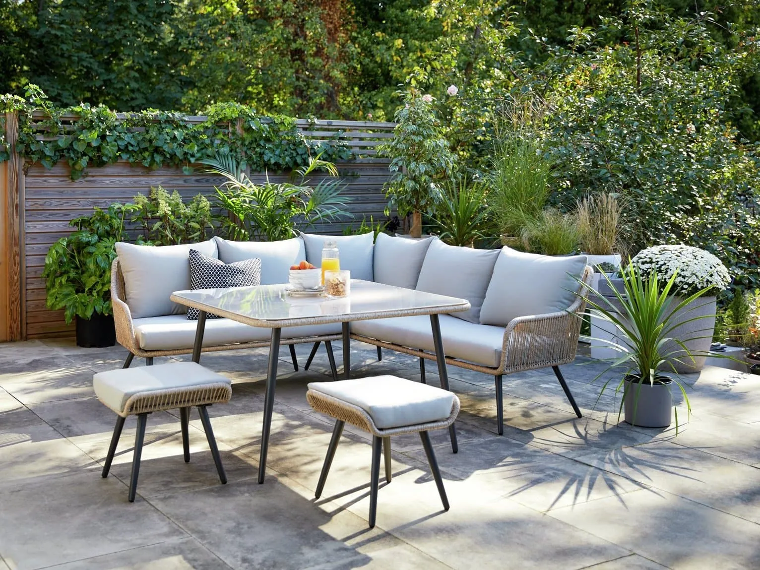 Rattan garden corner set with grey cushions and square table