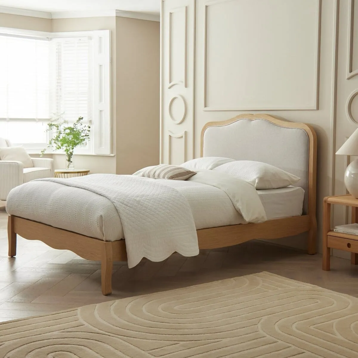 French-style oak bed frame with grey fabric padded headboard