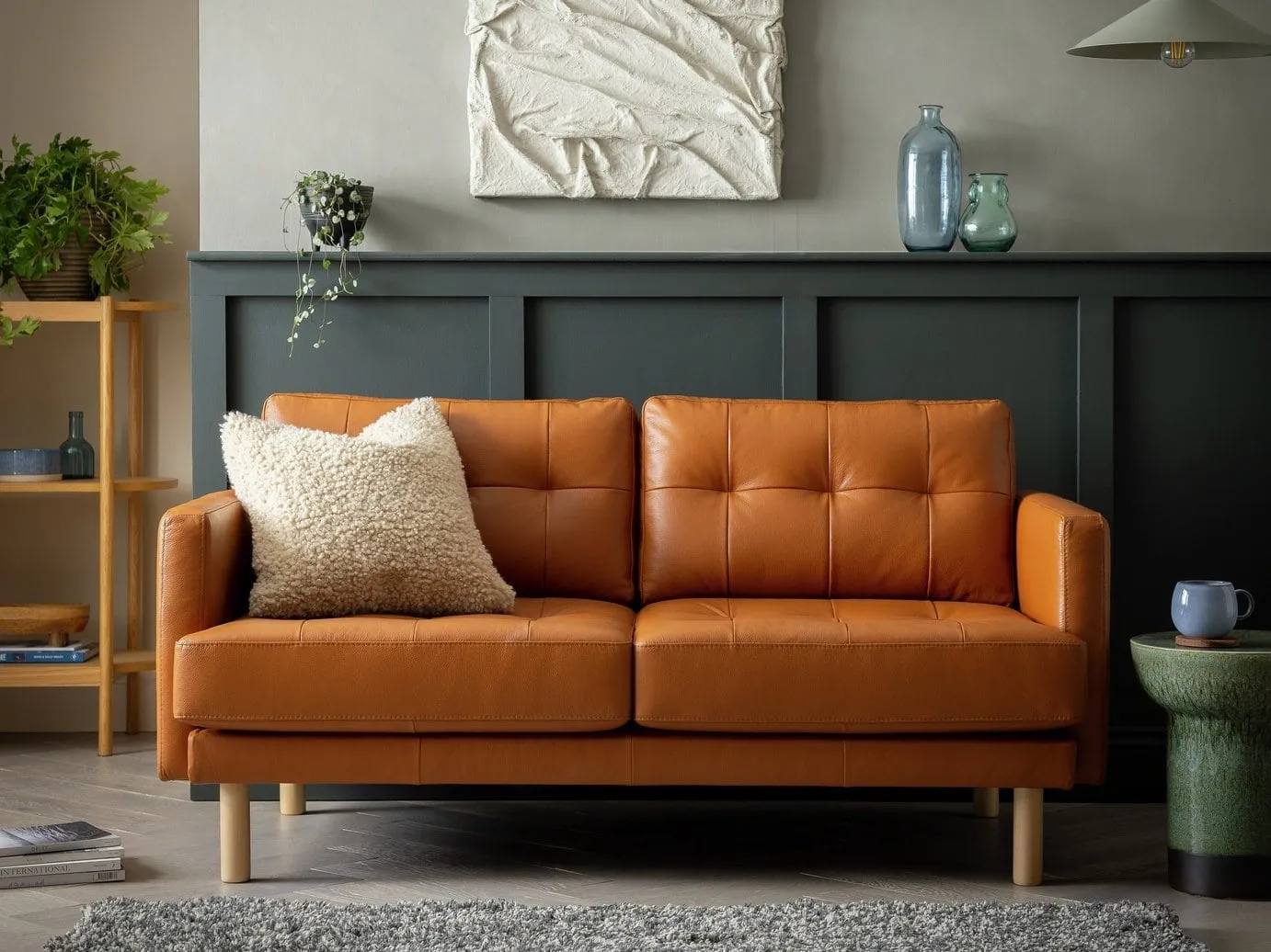 2-seater tan leather sofa with button back and wooden legs
