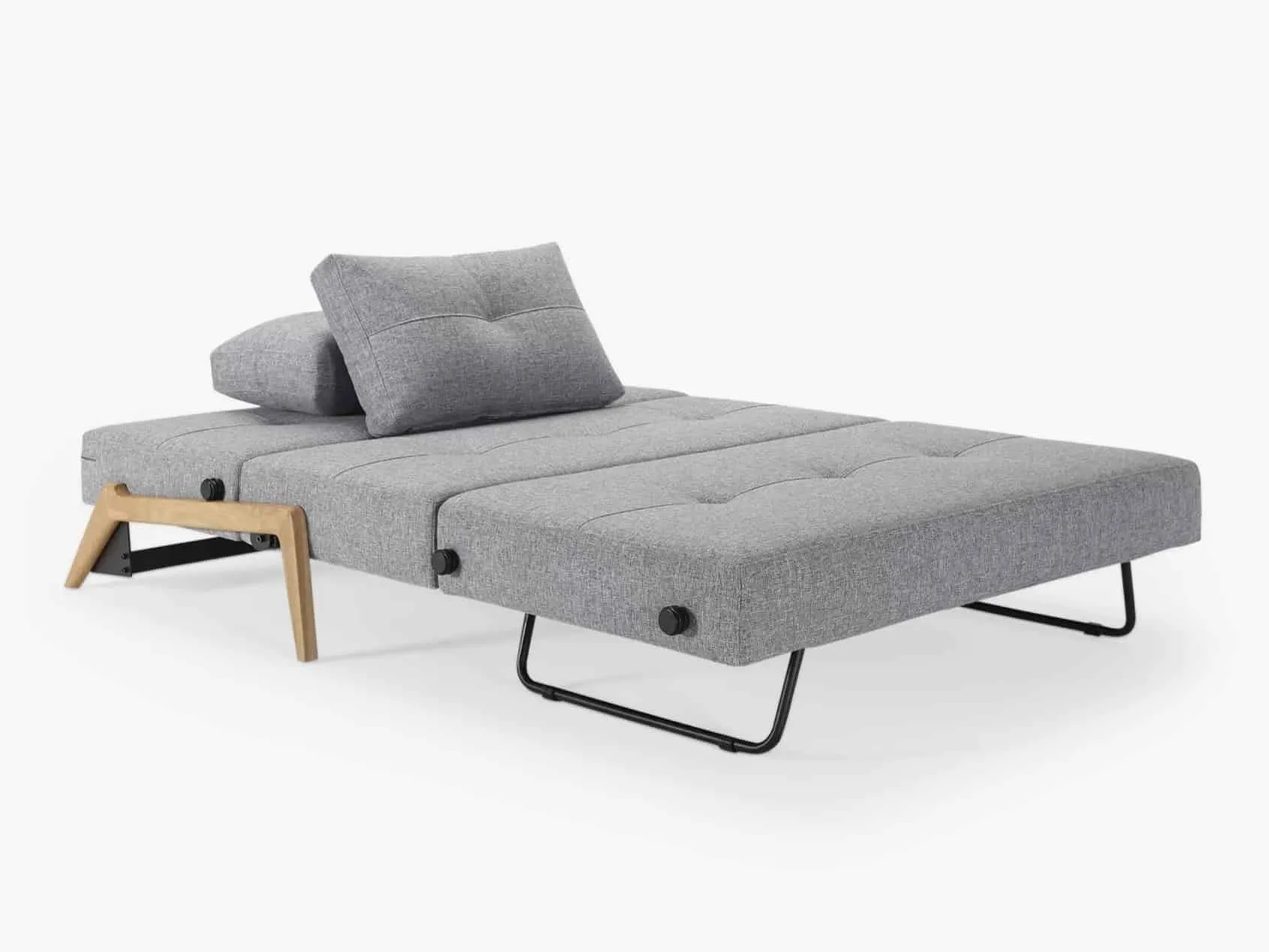 Grey fabric sofa bed laid flat with cushions