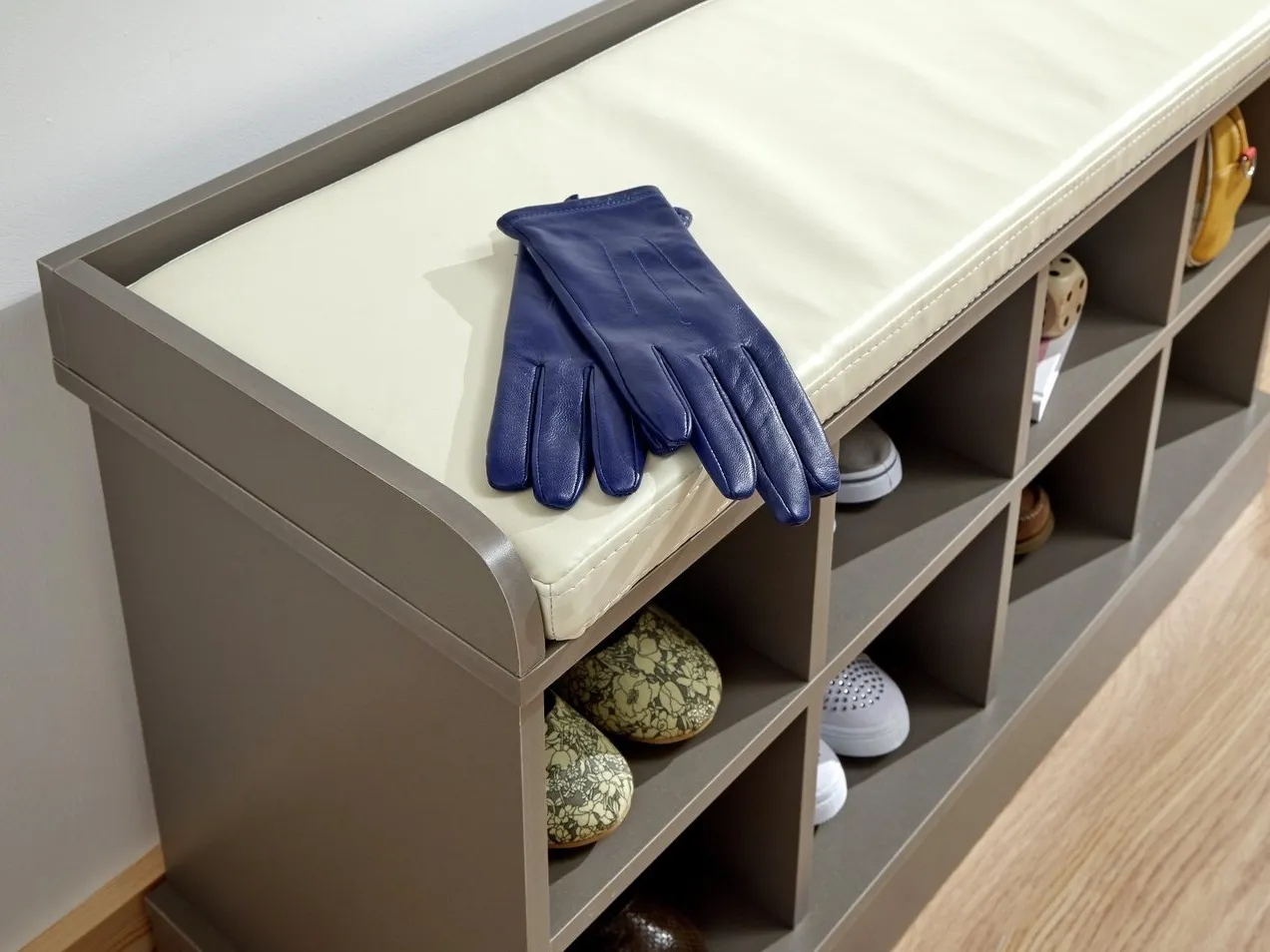 Grey-painte shoe bench with cream cushion