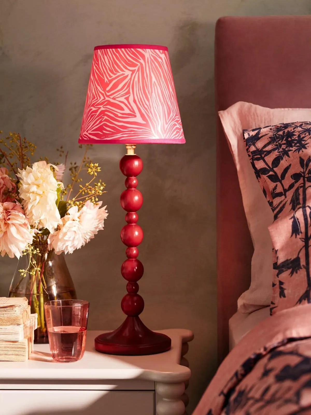 Red-painted bobbin-style table lamp