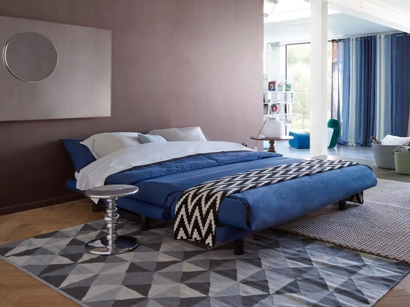 Blue fabric sofa bed laid flat