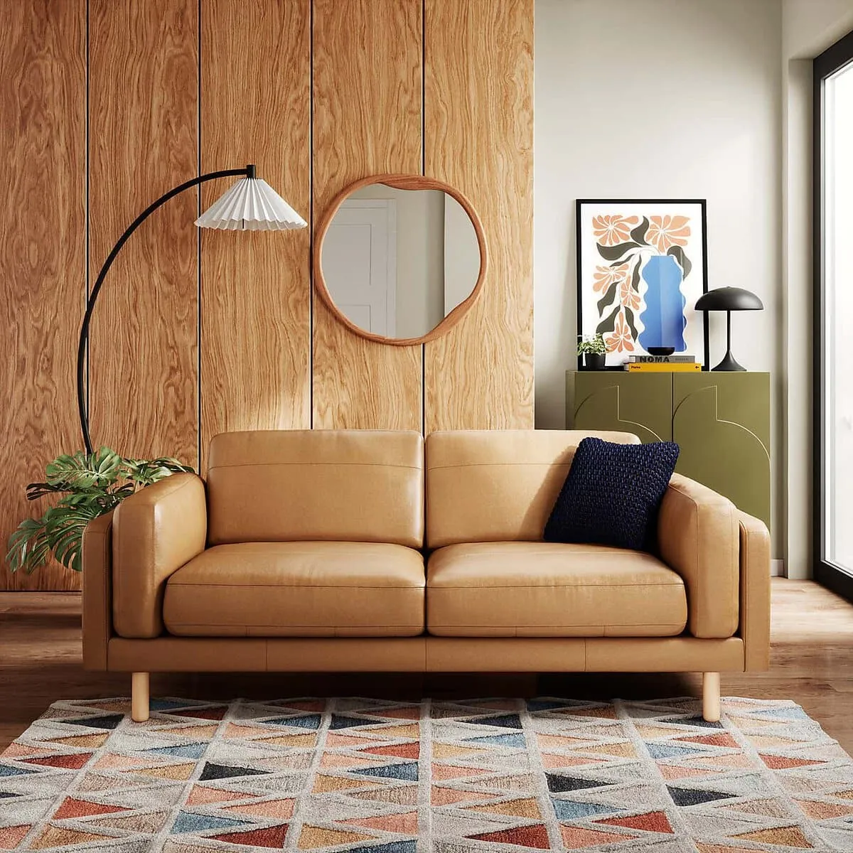 Tan leather sofa with wooden legs