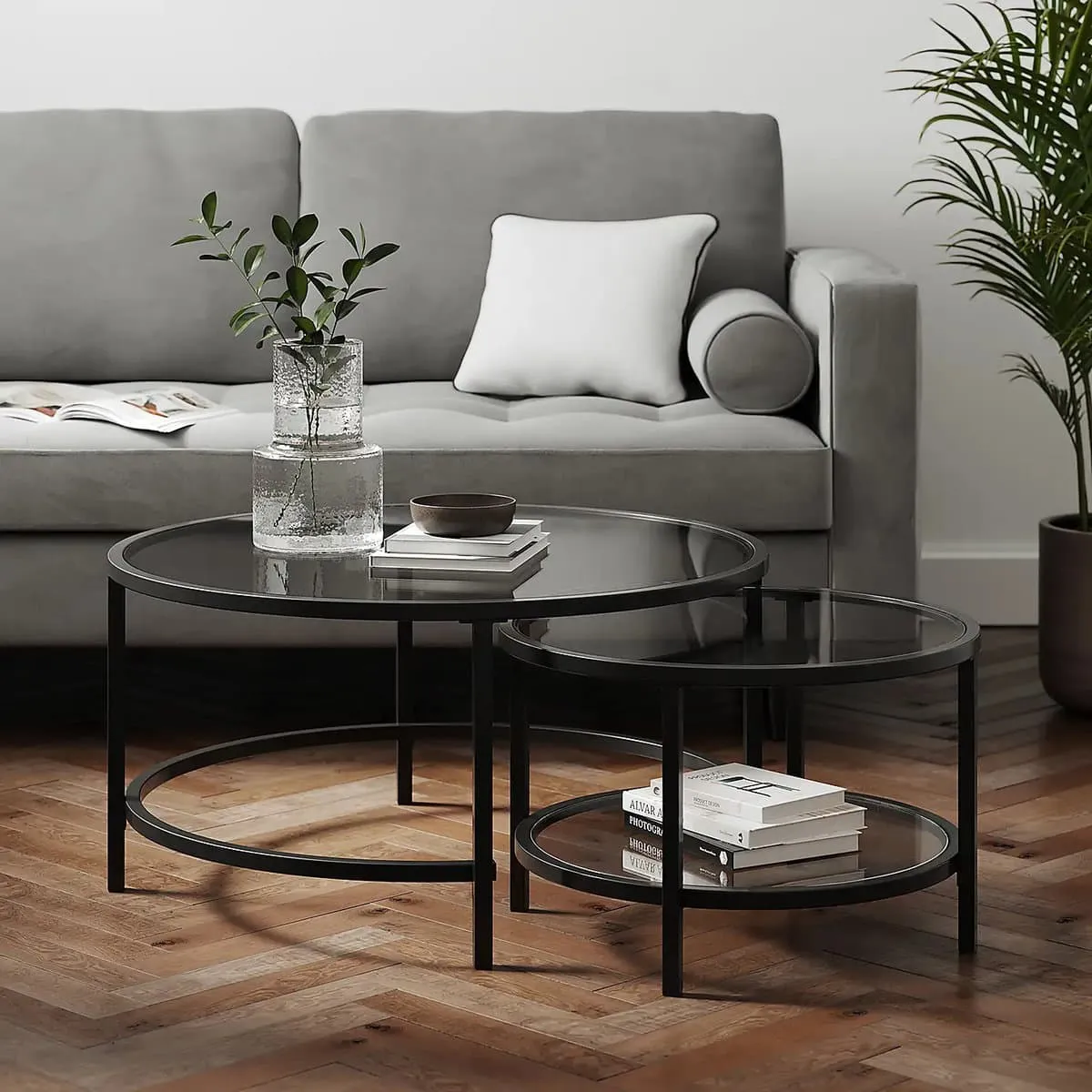 Pair of round black frame glass coffee tables