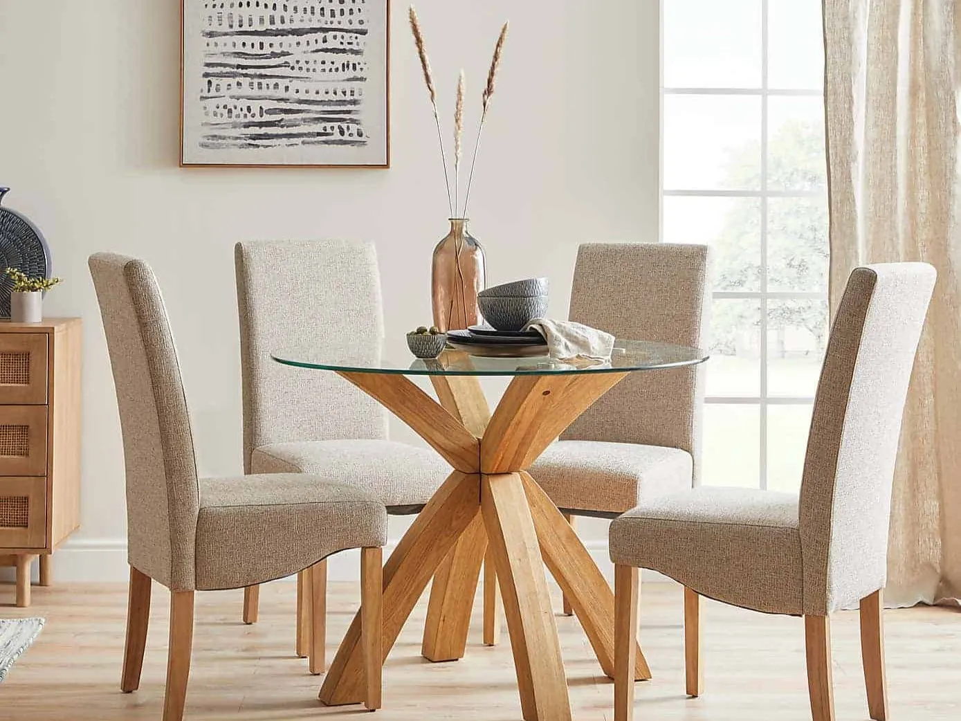 Oak dining table with curved legs and round glass top