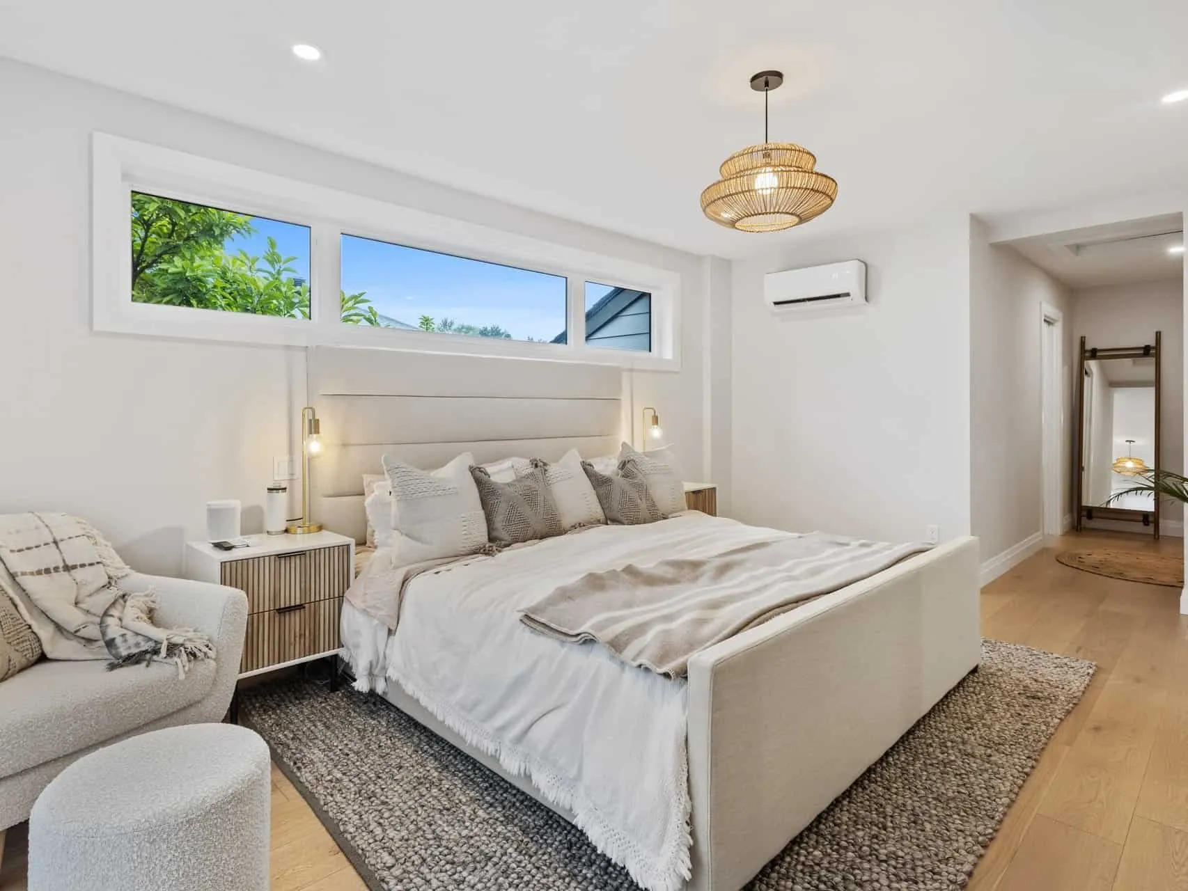 Hardwood bedroom floor with a large rug under the bed