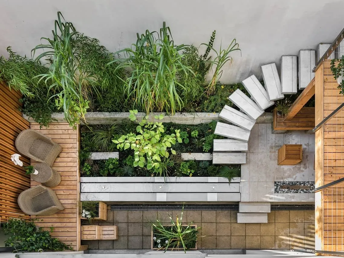 Compact garden space with planting area, decking and pavong.
