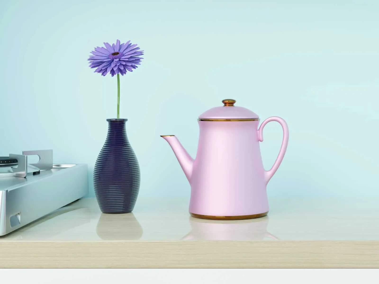 Pale blue kitchen wall with pink coffee pot and purple flower