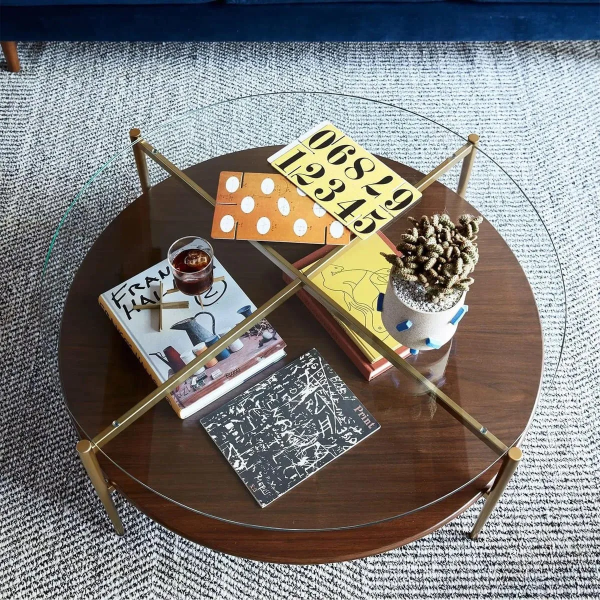 Round glass and walnut coffee table with antique brass frame
