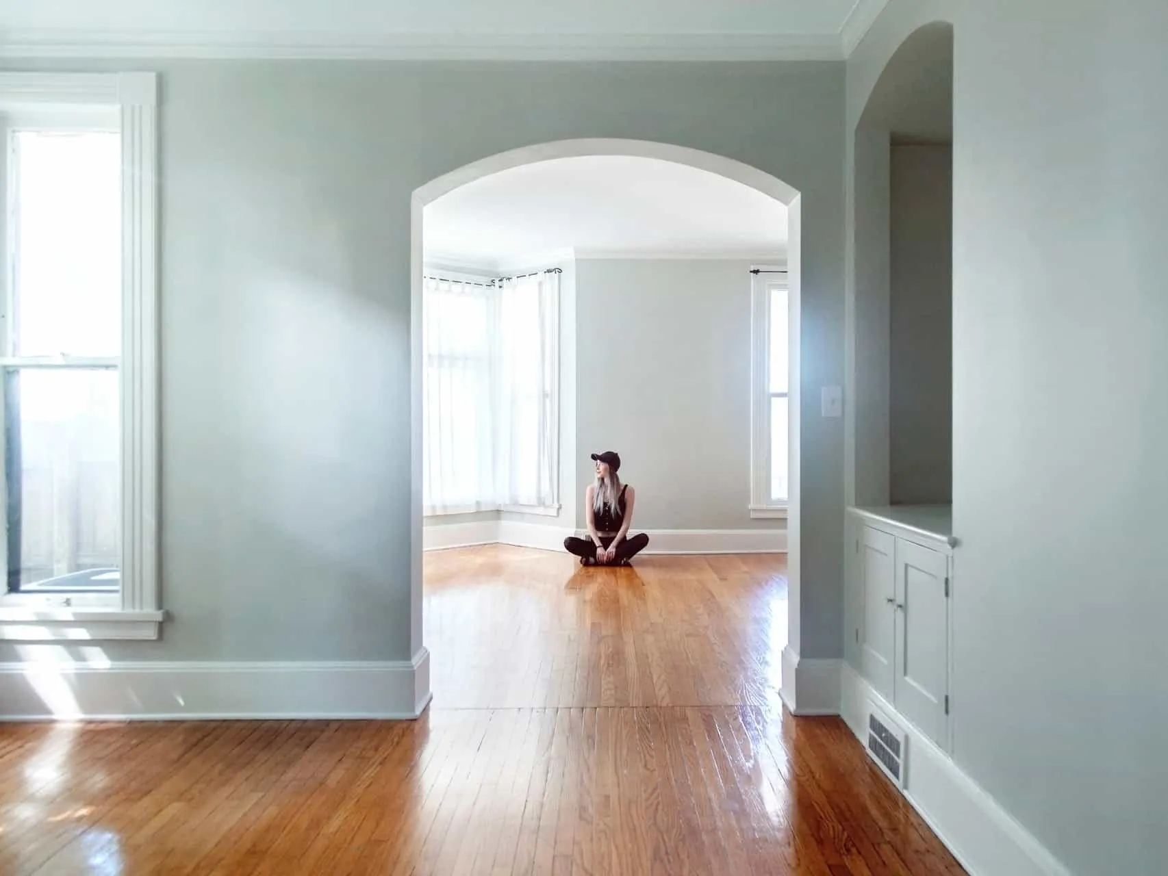 Girl sat on a polished wood floor